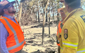 Waimakariri mayor Dan Gordon (left) looks over scorched trees where a fire has been burning in Loburn.