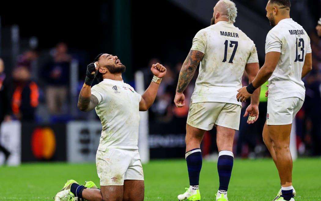 England's Manu Tuilagi celebrates with team-mates.