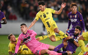 Ulises Davila leaps over Perth Glory goalkeeper Liam Reddy in their match at Eden Park earlier this season.