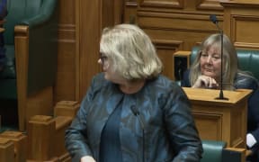 Minister Judith Collins looks back at colleague Mark Mitchell after Labour's Jan Tinetti brought up comments he made about women in a previous interview.