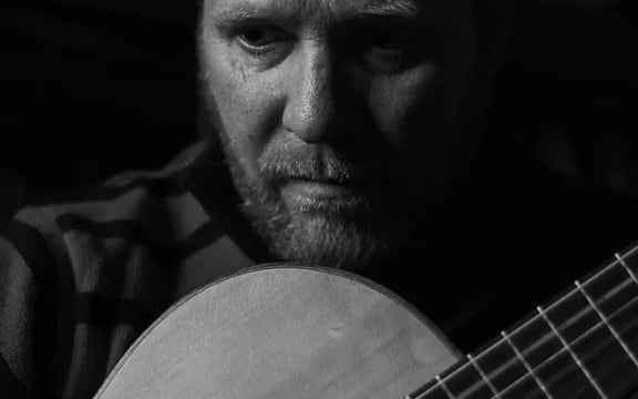 Composer Michael Hogan with guitar.