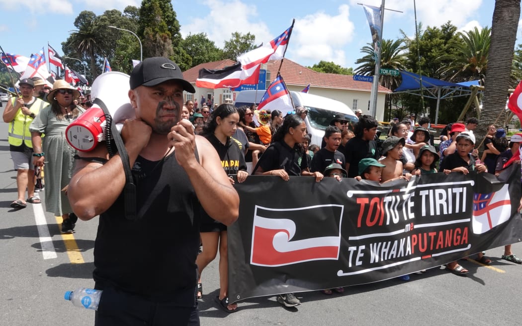 Wikatana Popata leads Friday’s hīkoi down the main street of Kaitāia.