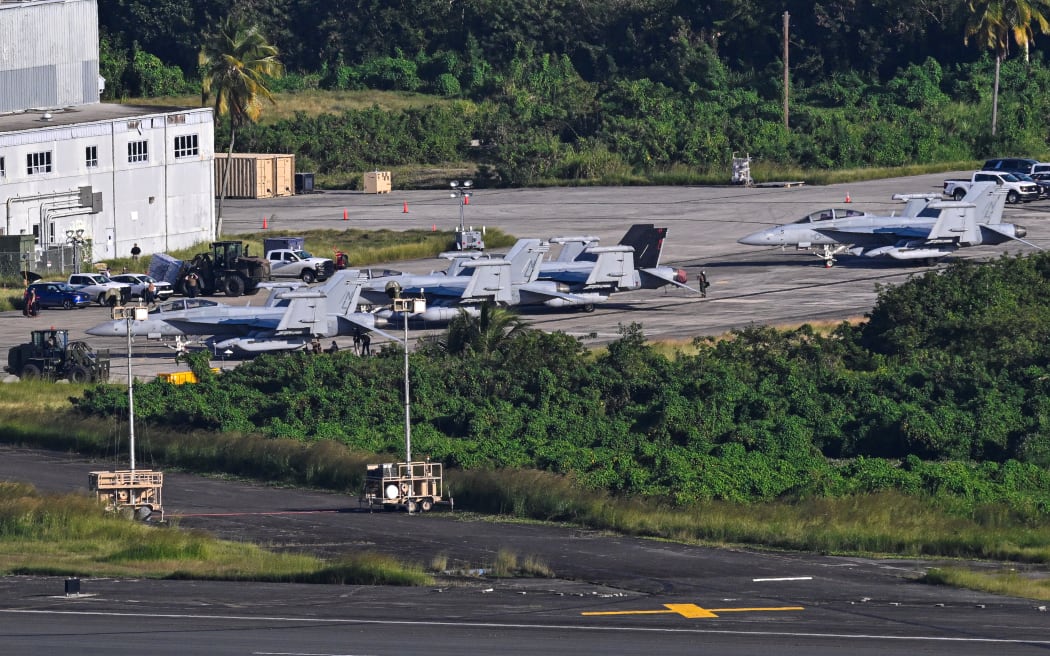 US Navy Boeing EA-18G Growlers sit on on the tarmac at José Aponte de la Torre Airport, formerly Roosevelt Roads Naval Station, on December 15, 2025 in Ceiba, Puerto Rico. Aircraft movements and coordinated exercises were observed throughout the day as part of heightened regional military readiness linked to ongoing operations at US military bases and maritime security efforts in the Caribbean. President Donald Trump administration is conducting a military campaign in the Caribbean and eastern Pacific, deploying naval and air forces for what it calls an anti-drugs offensive. (Photo by Miguel J. Rodriguez Carrillo / AFP)