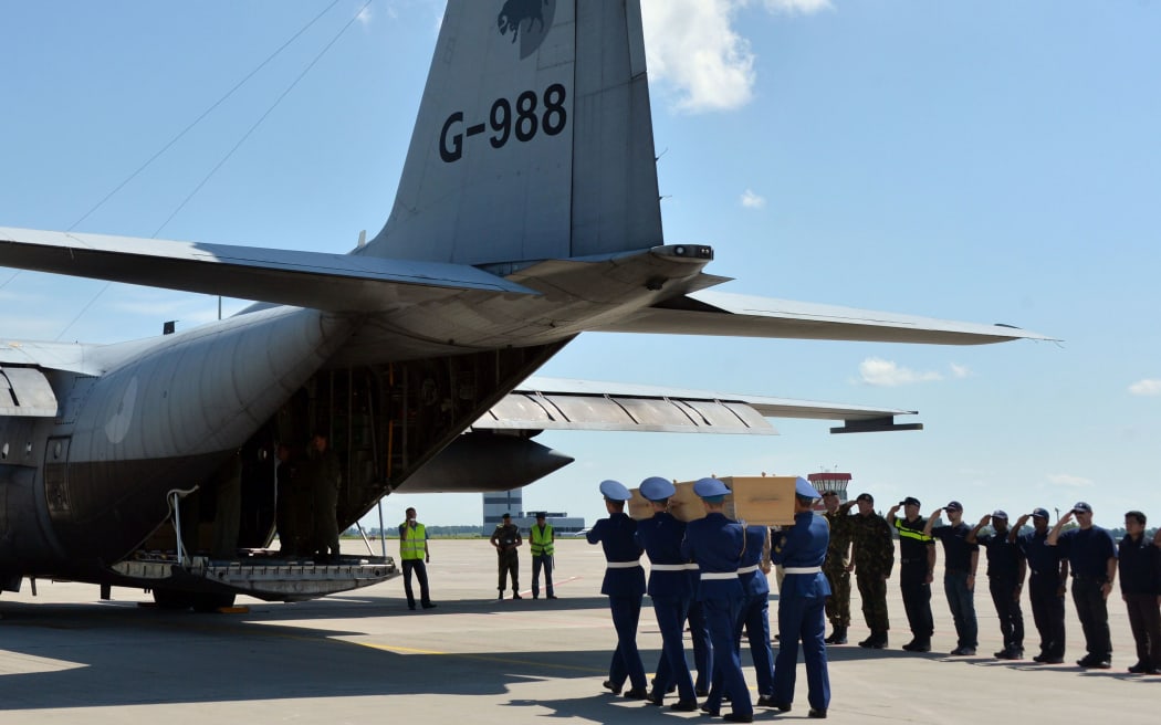 The first plane carrying bodies from Flight MH17 touched down at Eindhoven air base.