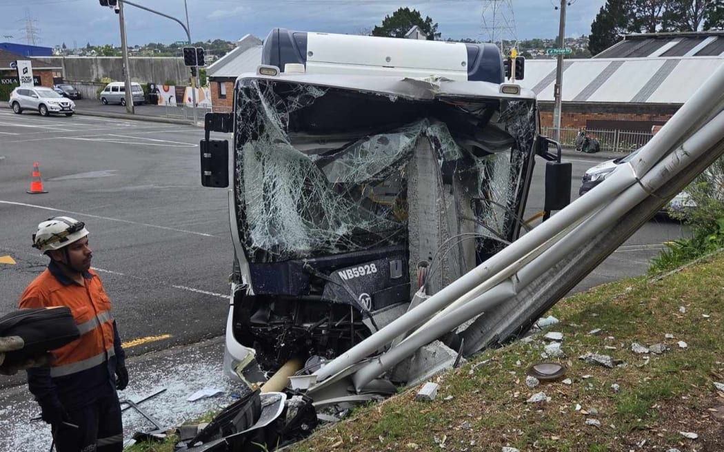 A bus has collided with a power pole in New Lynn, causing damage to Green Bay Auctions.