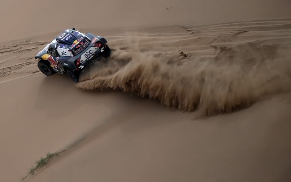 Mini's driver Stephane Peterhansel and his co-driver Edouard Boulanger of France compete during the Stage 11 of the Dakar 2020 between Alula and Yanbu, Saudi Arabia, on January 14, 2021.