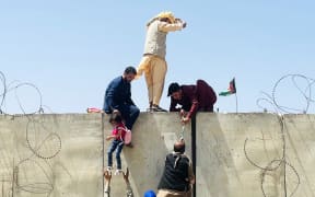 KABUL, AFGHANISTAN-AUGUST 16: Thousands of Afghans rush to the Hamid Karzai International Airport as they try to flee the Afghan capital of Kabul, Afghanistan, on August 16, 2021.