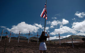 Lots of crosses are attached by local residents to mourn the victims on a hill overlooking Lahaina, the western part of the Maui island, which has been devastated by wildfire, in Maui, Hawaii, United States on August 22, 2023.( The Yomiuri Shimbun ) (Photo by Hiroto Sekiguchi / Yomiuri / The Yomiuri Shimbun via AFP)