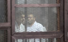 Some of 183 people who were sentenced to death after being found guilty of killing 11 policemen are seen in glass cages at the Tora Prison in Cairo, Egypt on February 02, 2015.