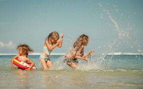 Happy kids playing on the beach at the day time - weather, heat, hot, summer, sun