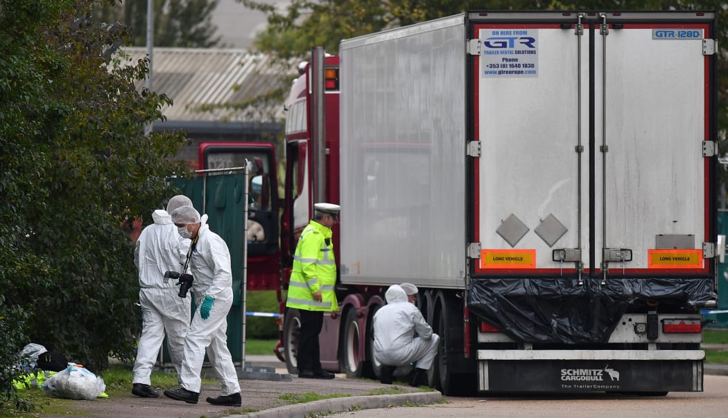 British forensics officers work on a lorry, found to be containing 39 dead bodies, east of London, 23 October 2019.