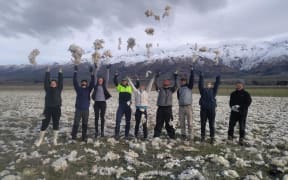 Workers from Tinwald Farm after spreading wool over a degraded paddock.