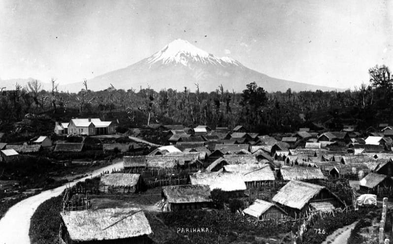 Parihaka Pa, circa 1900, with Mount Taranaki - taken by an unidentified photographer.