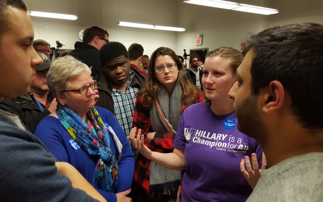 Hillary Clinton supporters make the pitch to undecided voters at the Democrats caucus in Des Moines.
