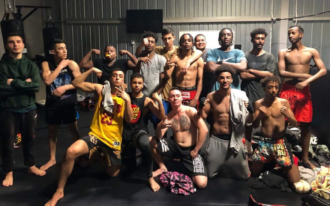 A group of young New Zealand men after a mixed martial arts training session.