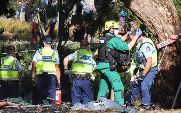 A police officer receives first aid in Parliament's garden