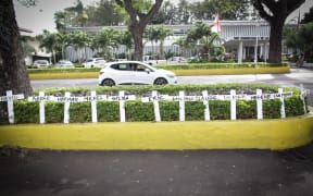 A picture taken on October 8, 2018 shows crosses bearing names of victims set in front of Papeete Court house, on the first day of the trial of Air Moorea company, 11-years after the crash of one of its aircrafts in which 20 people were killed.
