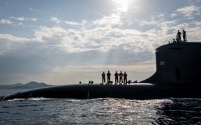 This handout picture taken on July 18, 2020 and released on October 20, 2020 by French shipbuilder Naval Group shows new French navy nuclear attack submarine Suffren, a Barracuda class, arriving at Toulon's naval base. (Photo by -