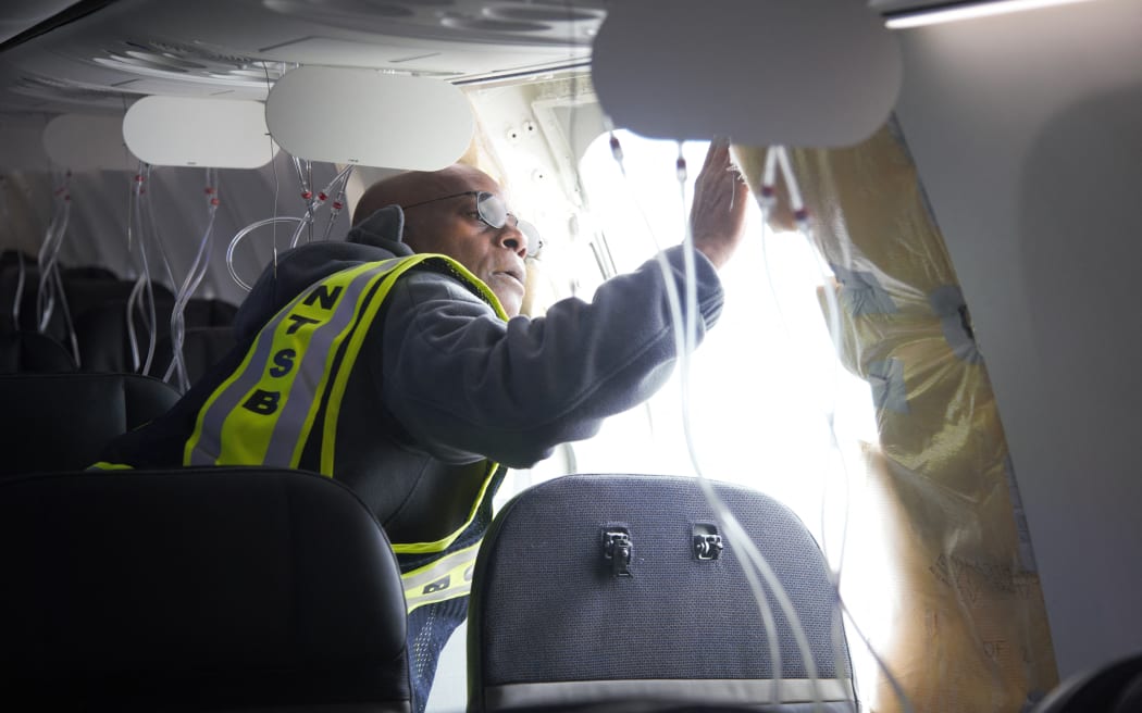 This handout picture provided by the NTSB on January 8, 2024 shows the investigation involving Alaska Airlines Flight 1282 on a Boeing 737-9 MAX in Portland, Oregon on January 7, 2024. US aviation authorities said January 7, 2024 the door plug of an airplane panel that blew out during an Alaska Airlines flight has been found, a part that could potentially help with the investigations into the cause of the accident.