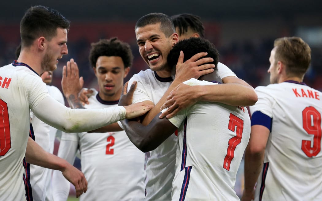 England's defender Bukayo Saka is mobbed by teammates after scoring the opening goal during the international friendly football match against Austria at the Riverside Stadium in Middlesbrough, north-east England on June 2, 2021.