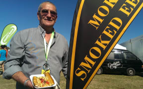 Robert Dawson holding a meal of traditionally cooked eel.