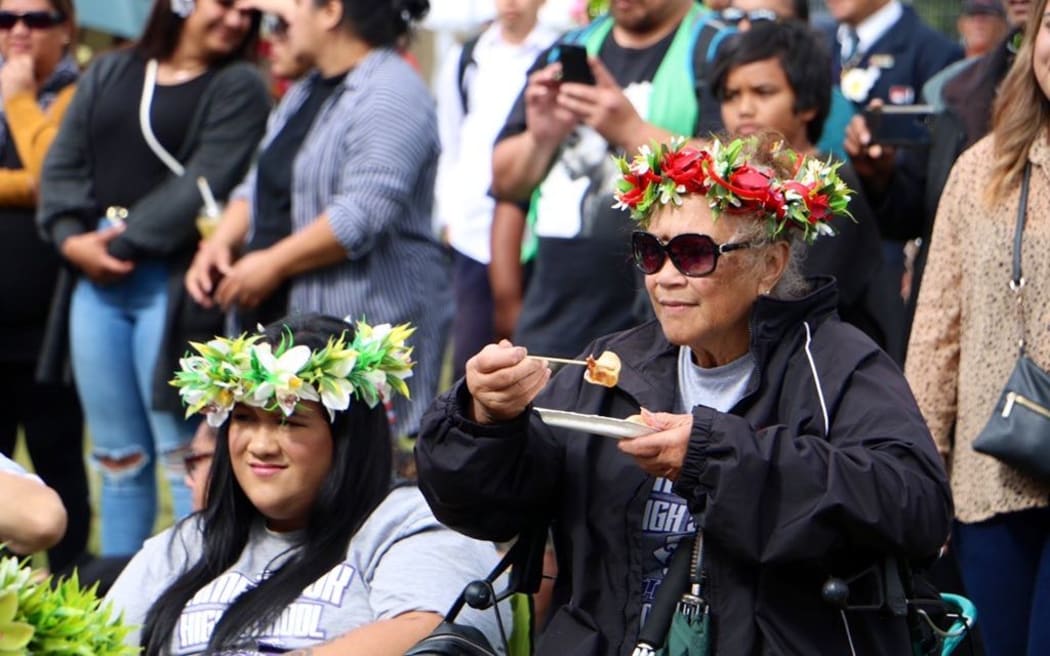 Cook Island mama enjoying a meal while watching performances - day 2 Polyfest 2021