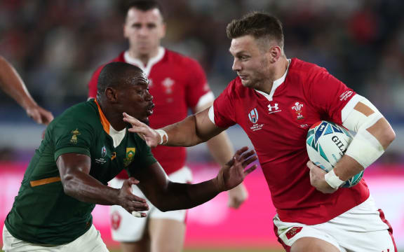 South Africa's wing Makazole Mapimpi (L) tackles Wales' first five Dan Biggar during the Japan 2019 Rugby World Cup semi-final match between Wales and South Africa.