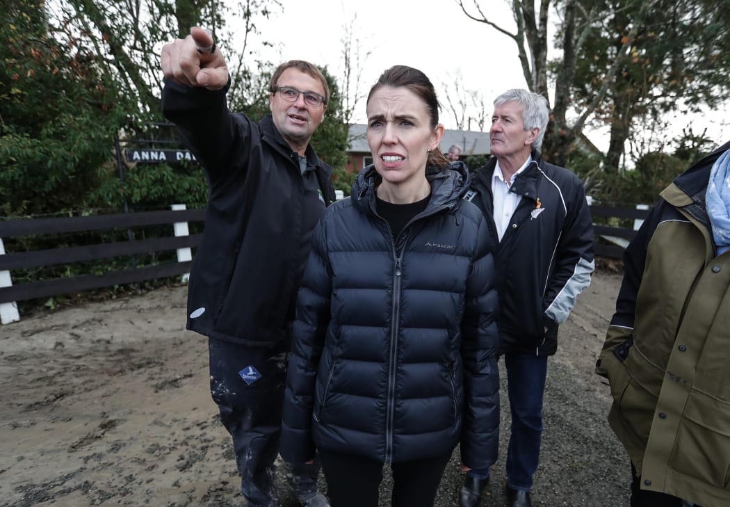 Chris Allen points out the damage caused by recent flooding to New Zealand Prime Minister, Jacinda Ardern.