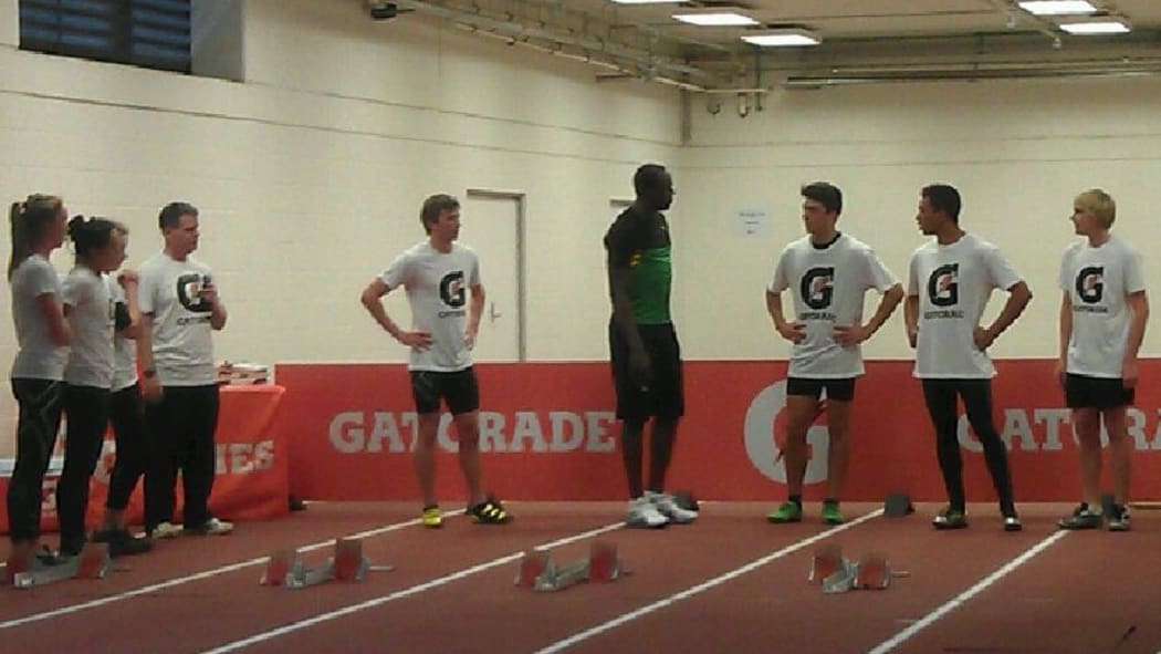 Bolt shares some tips with promising sprinters at the Millennium Institute.