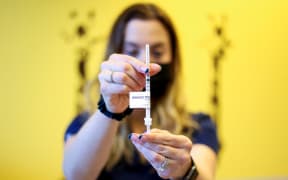DENVER, CO - NOVEMBER 03: National Jewish Health registered nurse Lindsay Waldman holds out a dose of the pediatric COVID-19 vaccine on November 3, 2021 in Denver, Colorado.