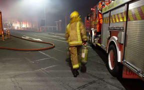 Firefighters enter burning building in Christchurch.