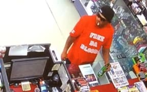 The attacker, as pictured, was wearing a red t-shirt and black jeans with a red bandana tucked in to the waistline.