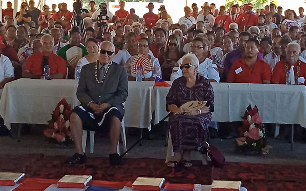 Former Samoan head of state Tui Atua (front L) and his wife Masiofo Filifilia Tamasese (front R) attend the swearing in of Samoa's first woman prime minister, Fiame Naomi Mata'afa (not pictured), in Apia on May 24, 2021, at an extraordinary makeshift tent ceremony