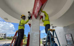 Workers secure a gas station on 3 July, 2026, ahead of the arrival of the forecasted Super Typhoon Bavi in Saipan, Northern Mariana Islands.