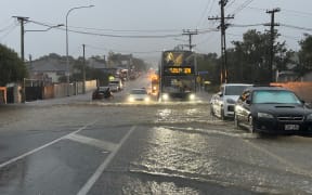 The bus to Mt Eden makes its way through floodwaters