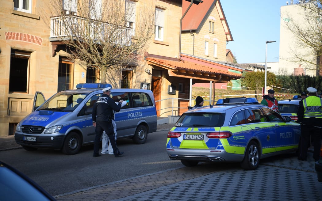 Police cars are seen at the site where a shooter, believed to have a personal motive, launched an assault on January 24, 2020 in the town of Rot am See in southwestern Germany.