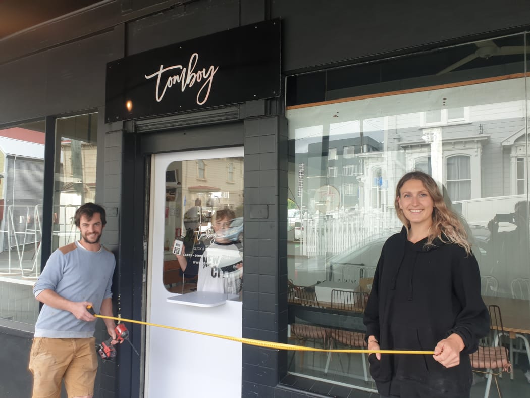 Tomboy cakery and café owner Kate Marinkovich tries out her new door which will her to to do contactless pickup.