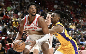 LAS VEGAS, NEVADA - JULY 17: Rob Baker II #35 of the Atlanta Hawks dribbles the ball past Sean East II #29 of the Los Angeles Lakers in the second half of a 2024 NBA Summer League game at the Thomas & Mack Center on July 17, 2024 in Las Vegas, Nevada. The Lakers defeated the Hawks 87-86. NOTE TO USER: User expressly acknowledges and agrees that, by downloading and or using this photograph, User is consenting to the terms and conditions of the Getty Images License Agreement. (Photo by Candice Ward/Getty Images)
