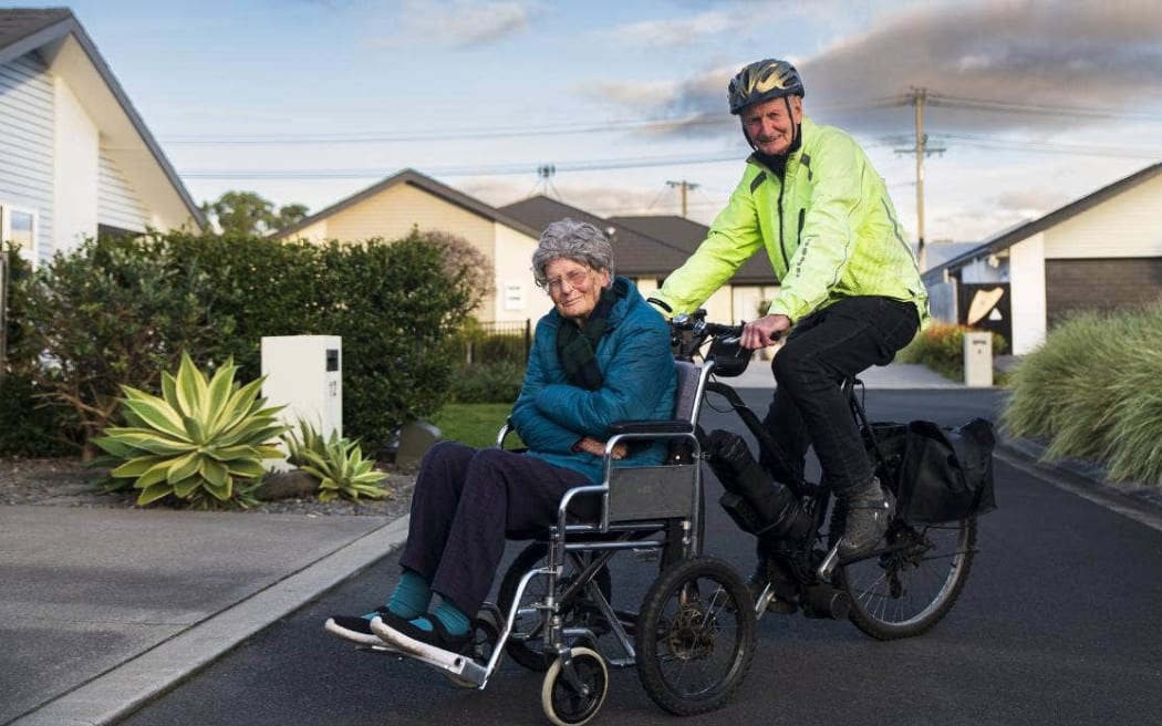 Kevin Harvey attached a wheelchair to the front of his electric bike so he can pedal his wife Beverley around the Coastal Walkway in New Plymouth.