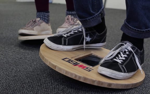 The mobile phone sitting the balance board works as a kind of joystick for the video game.