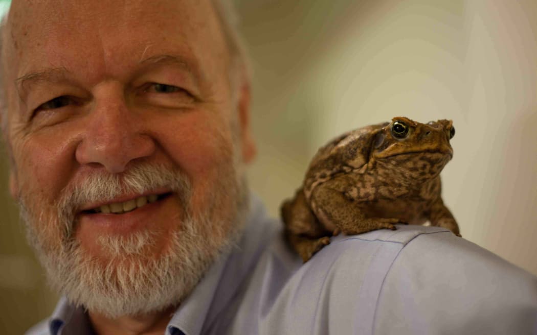 Professor Rick Shine with a cane toad on his shoulder