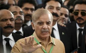 Pakistan's opposition leader Shehbaz Sharif speaks with the media before attending a hearing outside the Supreme Court building in Islamabad on April 7, 2022.
