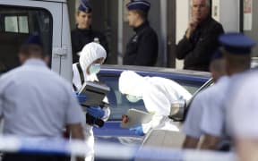 Police forensic experts at the scene of the shooting.