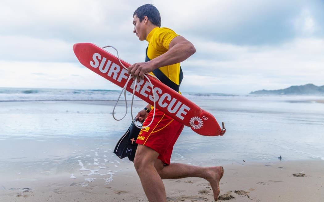 Surf Life guard running into the water