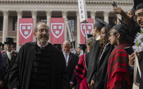 Harvard President Alan Garber walks the Tercentenary Theatre processional through Harvard Yard on May 28, 2025 in Cambridge, Massachusetts. The joyous occasion unfolds amid escalating tensions between Harvard and the Trump administration, which has ordered the cancellation of federal contracts valued at approximately $100 million.