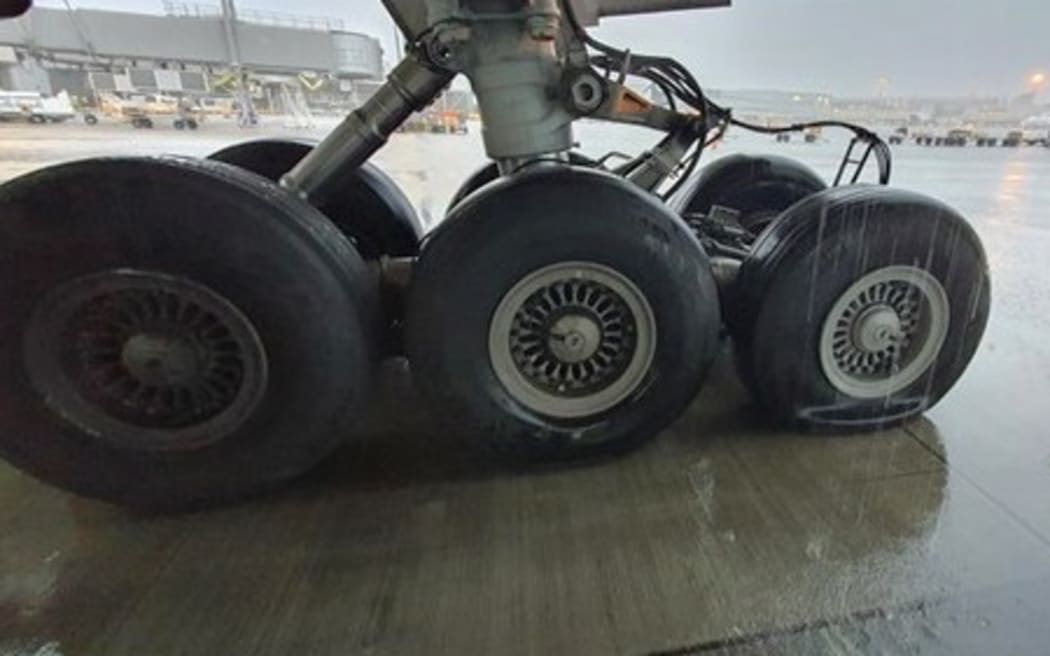The Boeing 777's right-hand landing gear with its deflated tyre.