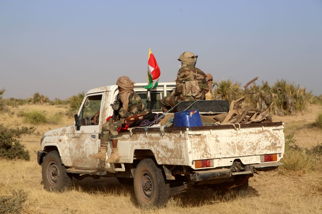Coalition of the People of Azawad (CPA) fighters are seen on a Land Cruiser while patrolling the area near the Mali-Mauritania border to protect local populations from insecurity related to unrest caused by bandits.