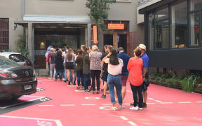 A queue forms for an open home viewing at Leeds Street apartments in Wellington.