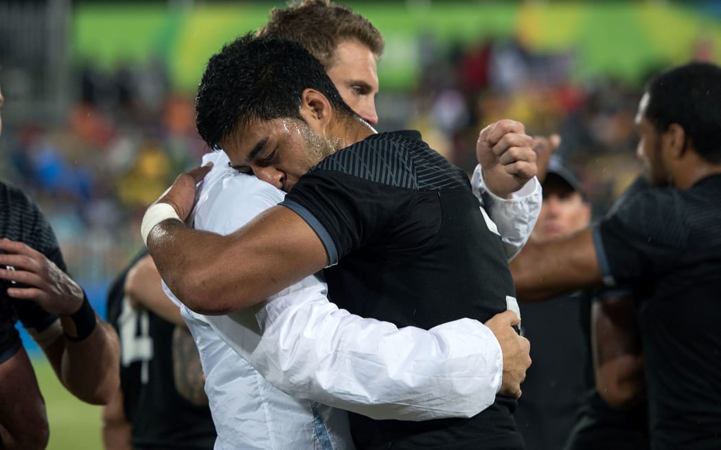 New Zealand's captain Scott Curry (left) gets a hug from team mate Akira Ioane after their quarter final loss to Fiji in the Men's rugby sevens at the Rio Olympics.