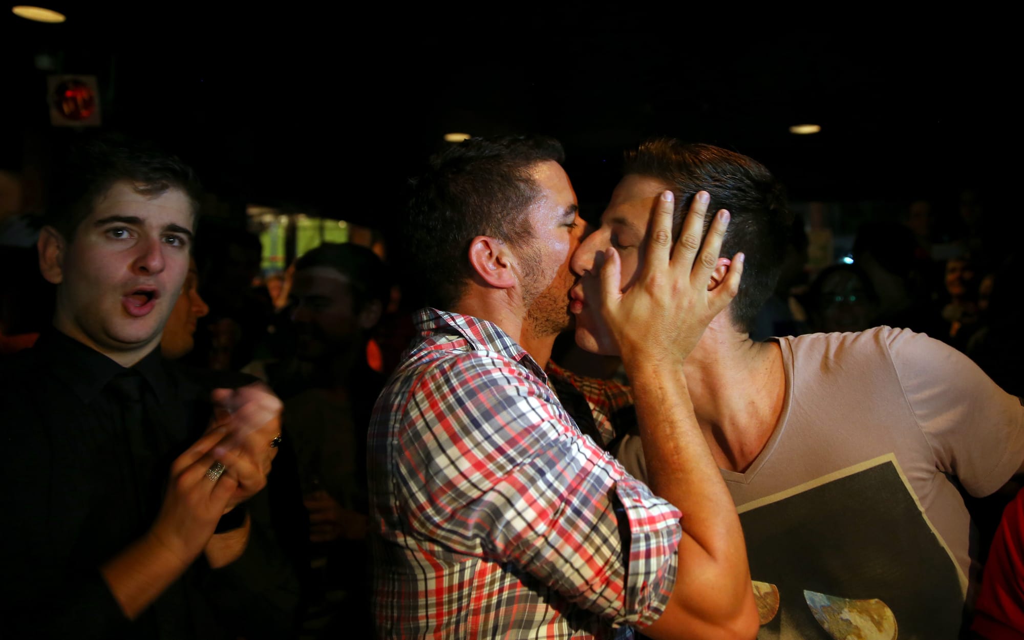 Marriage equality supporters celebrate in an Auckland bar after Louisa Wall's Marriage Equality Bill passes into law in 2013